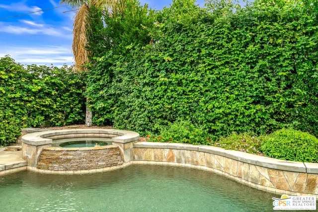 a view of a swimming pool with a garden