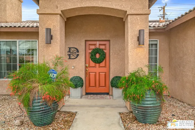a potted plant sitting in front of a house