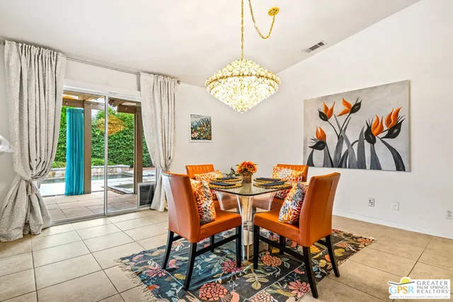 a view of a dining room with furniture wooden floor and chandelier