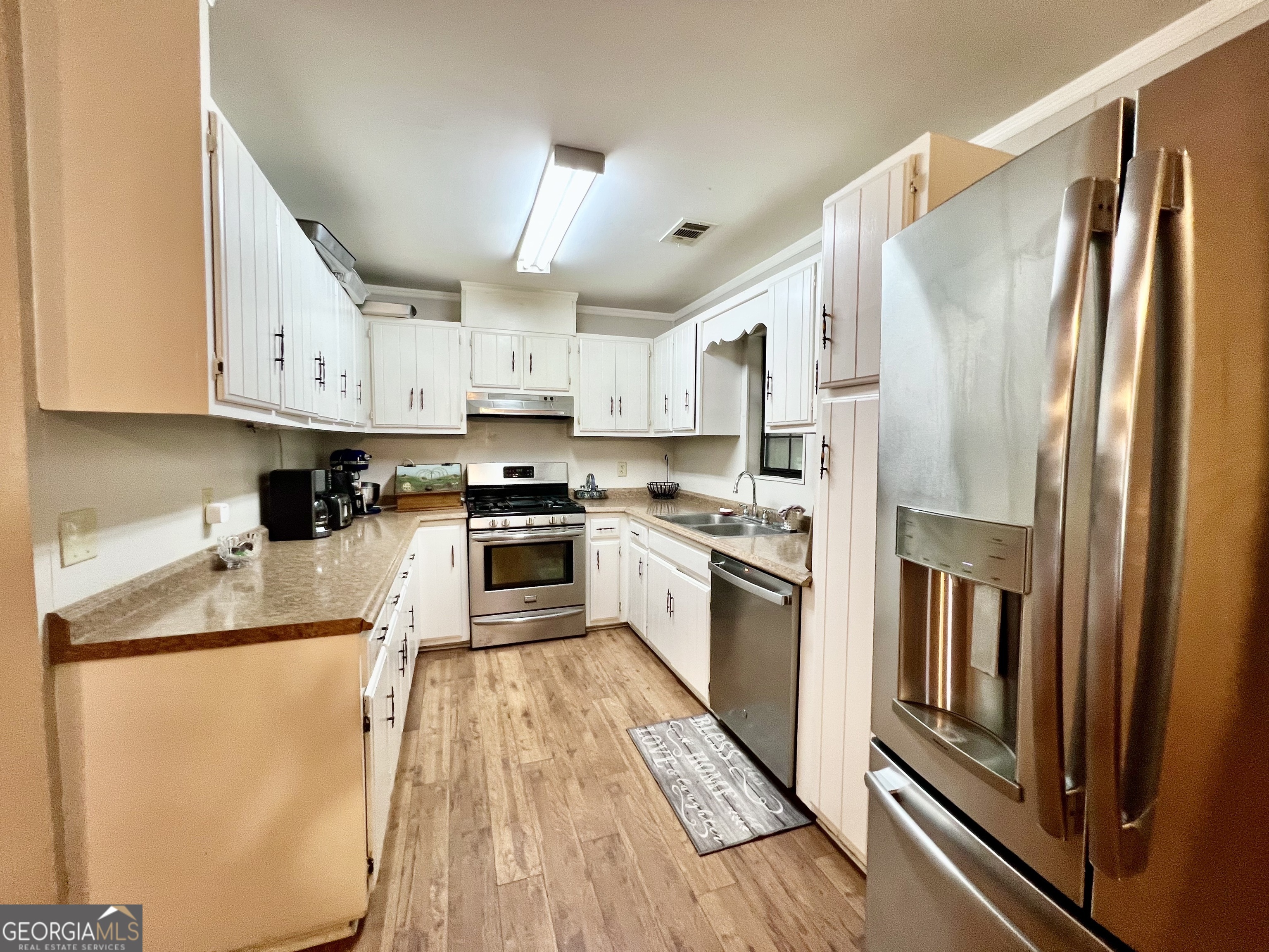 2618 Highway 86 Adrian, GA 31002 - Photo 13 of 27 a kitchen with stainless steel appliances granite countertop a refrigerator a stove and a sink