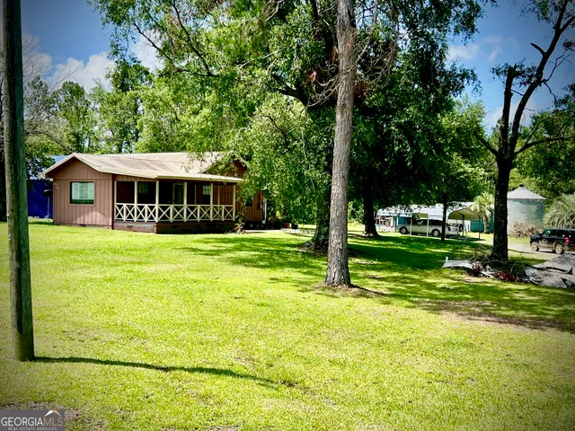 a view of house with a yard