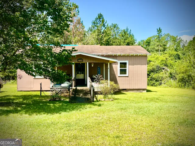 a view of a house with backyard porch and sitting area