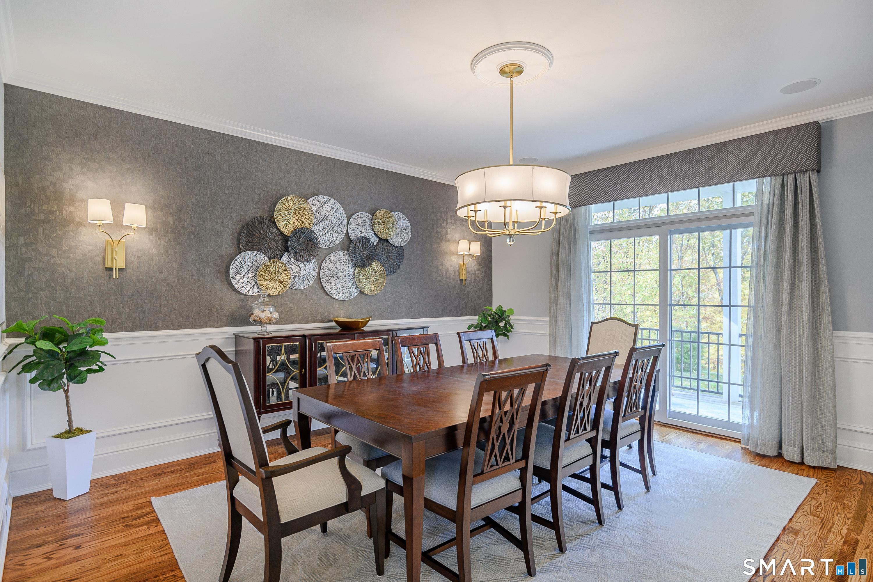 14 Merlins Lane Newtown, CT 06470 - Photo 13 of 40 Formal dining room with wainscoting and statement chandelier.