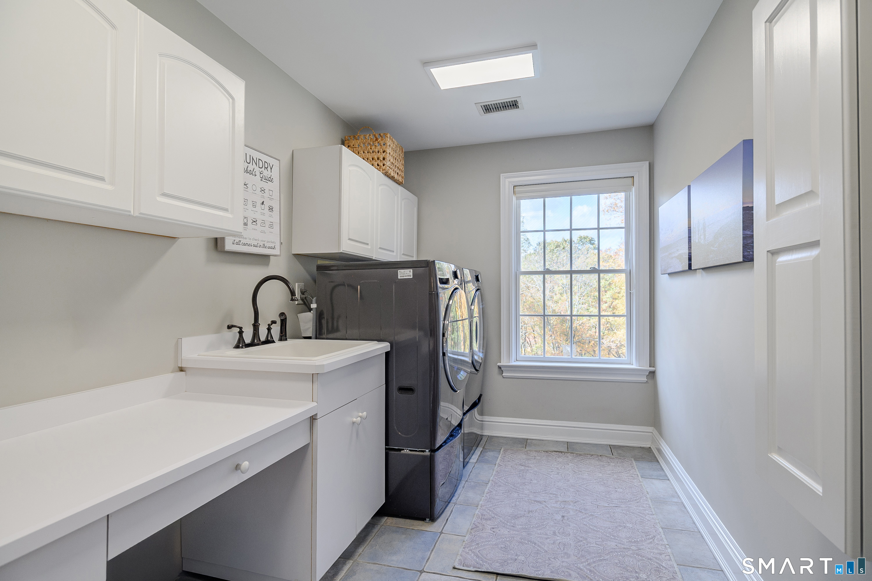 14 Merlins Lane Newtown, CT 06470 - Photo 23 of 40 Bright laundry room with sink & storage