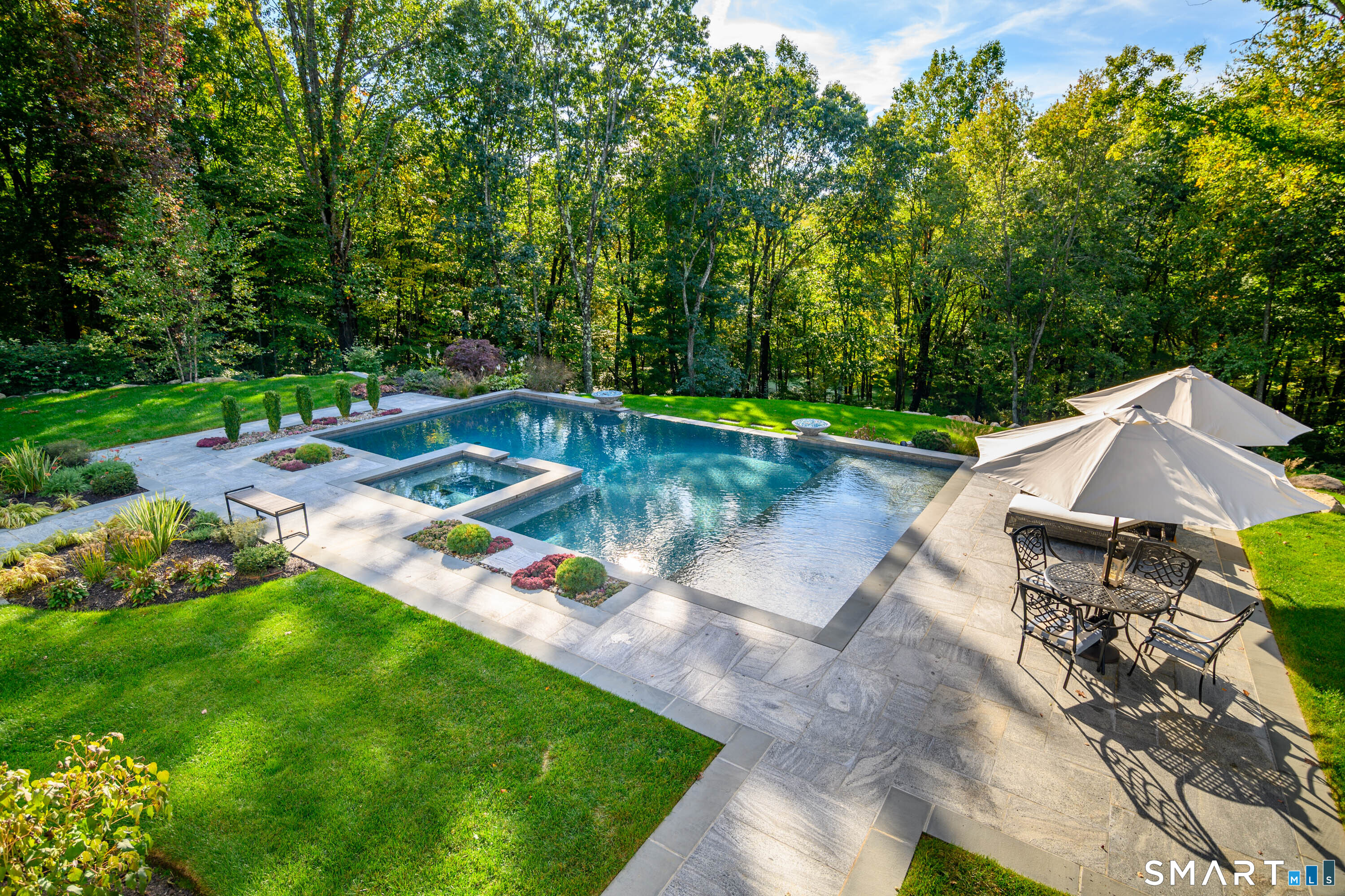 14 Merlins Lane Newtown, CT 06470 - Photo 35 of 40 Heated gunite pool with integrated spa and stone patio surround.