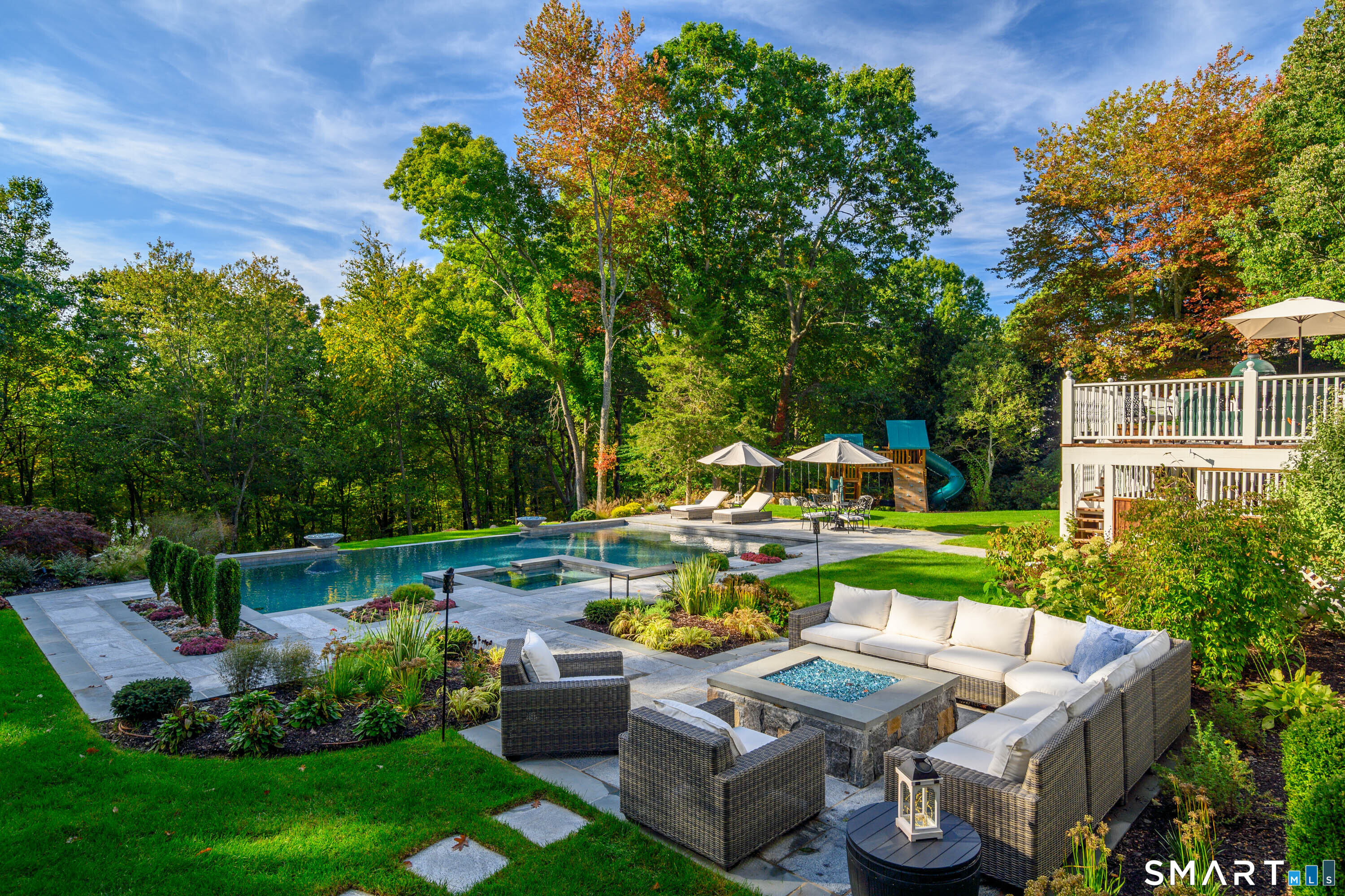 14 Merlins Lane Newtown, CT 06470 - Photo 37 of 40 Private backyard oasis with pool, patio, and lush landscaping.