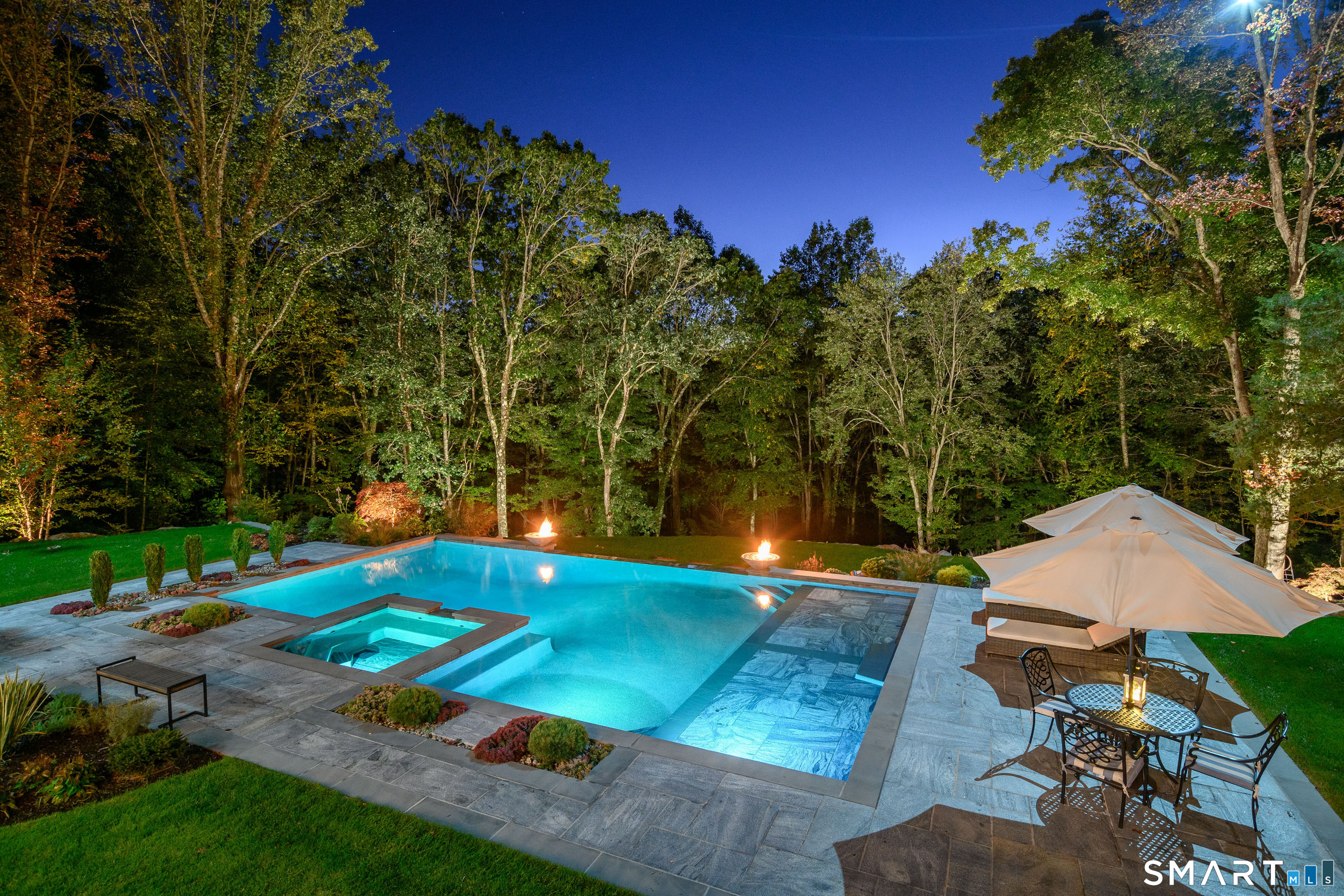 14 Merlins Lane Newtown, CT 06470 - Photo 40 of 40 Illuminated pool and spa with fire features.
