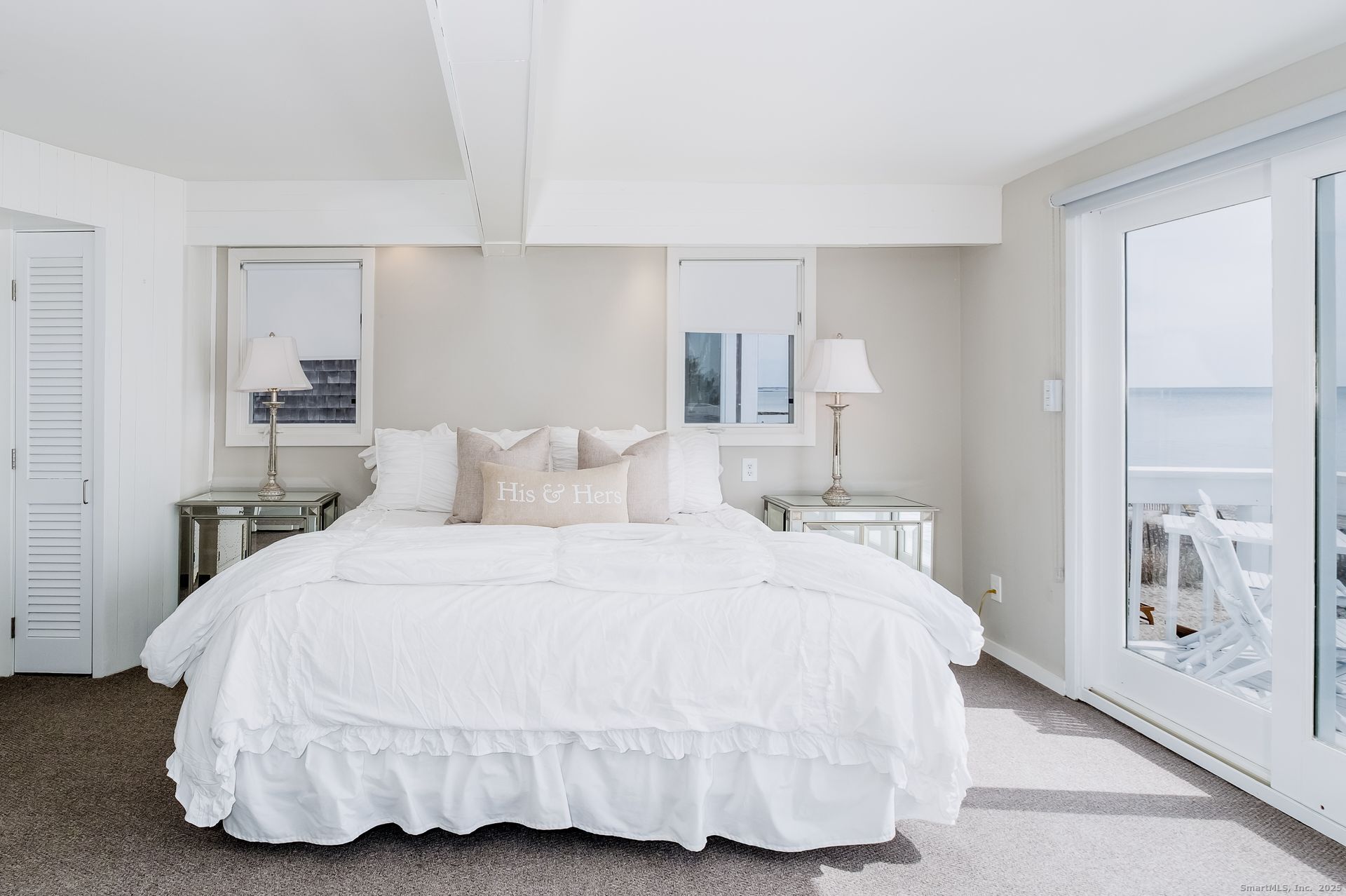 1987 Fairfield Beach Road Fairfield, CT 06824 - Photo 14 of 22 a bedroom with a bed and a lamp