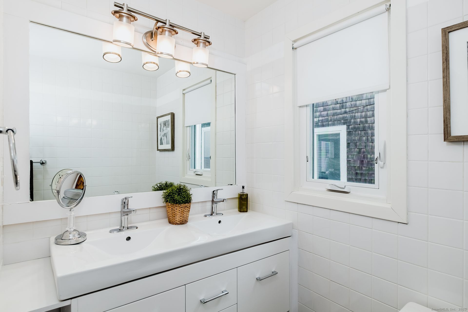 1987 Fairfield Beach Road Fairfield, CT 06824 - Photo 17 of 22 a bathroom with a sink and a mirror