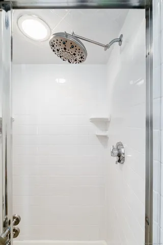 a spacious bedroom with a bed and a large window