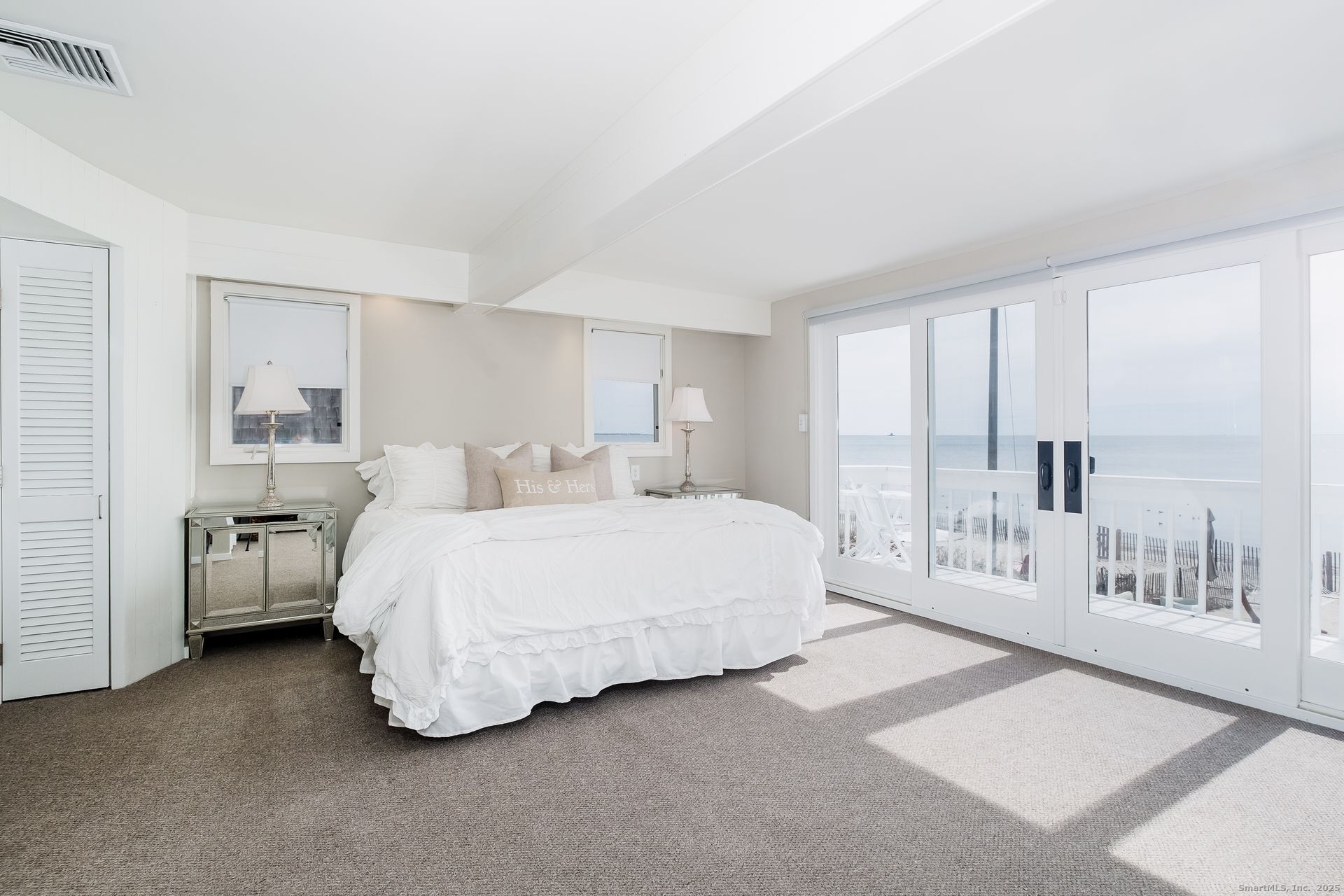 1987 Fairfield Beach Road Fairfield, CT 06824 - Photo 19 of 22 a spacious bedroom with a bed and a large window