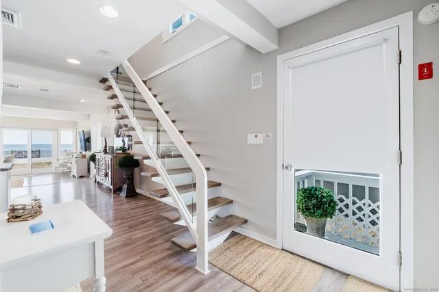 a view of entryway and hall with wooden floor