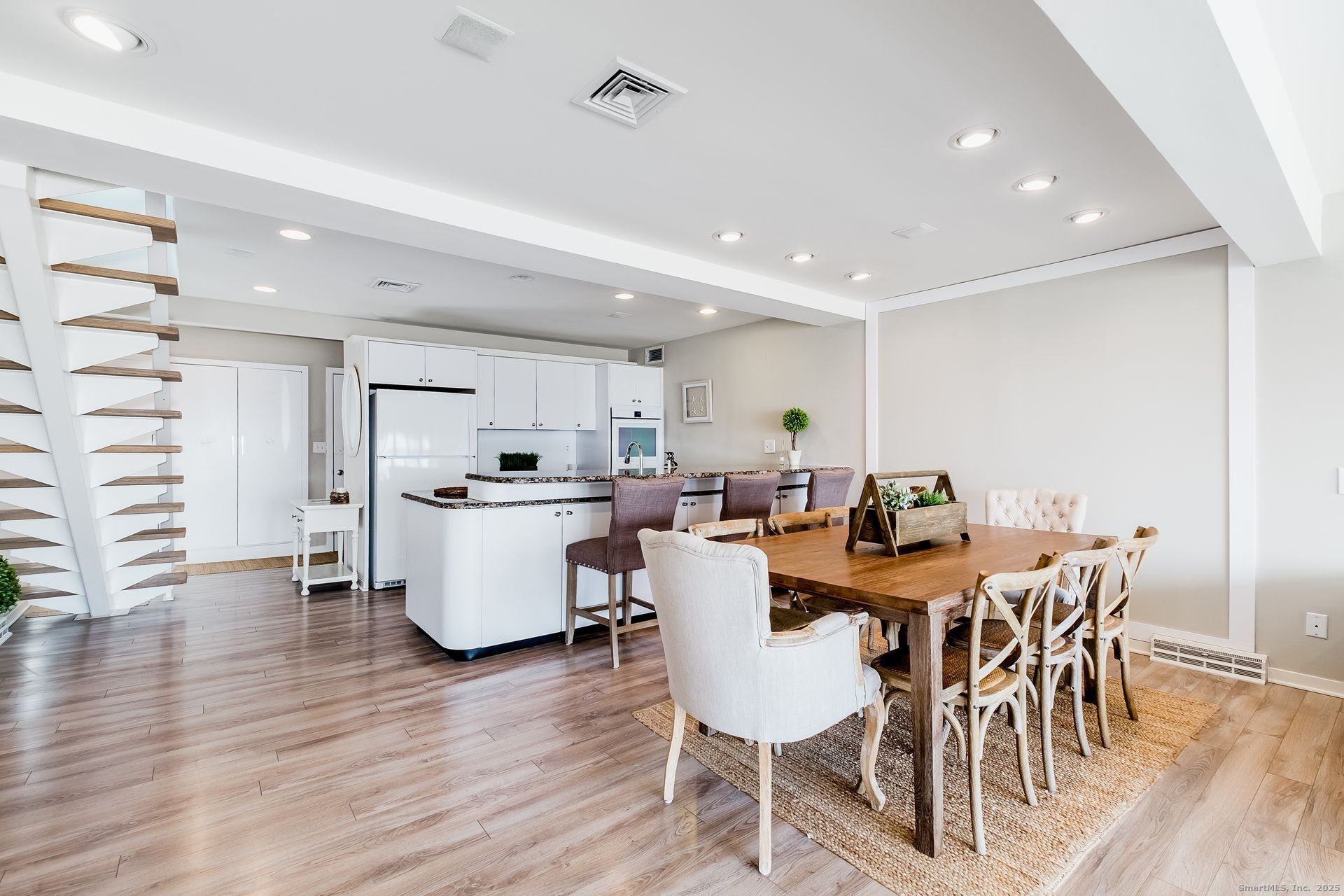 1987 Fairfield Beach Road Fairfield, CT 06824 - Photo 5 of 22 a view of a dining room with furniture and wooden floor