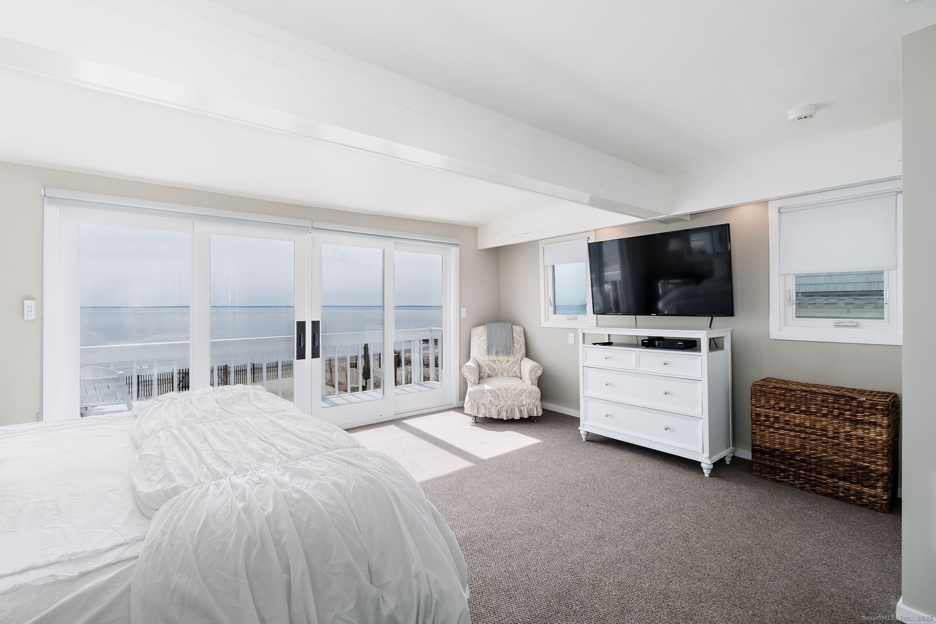 1987 Fairfield Beach Road Fairfield, CT 06824 - Photo 7 of 22 a bedroom with a bed and flat screen tv