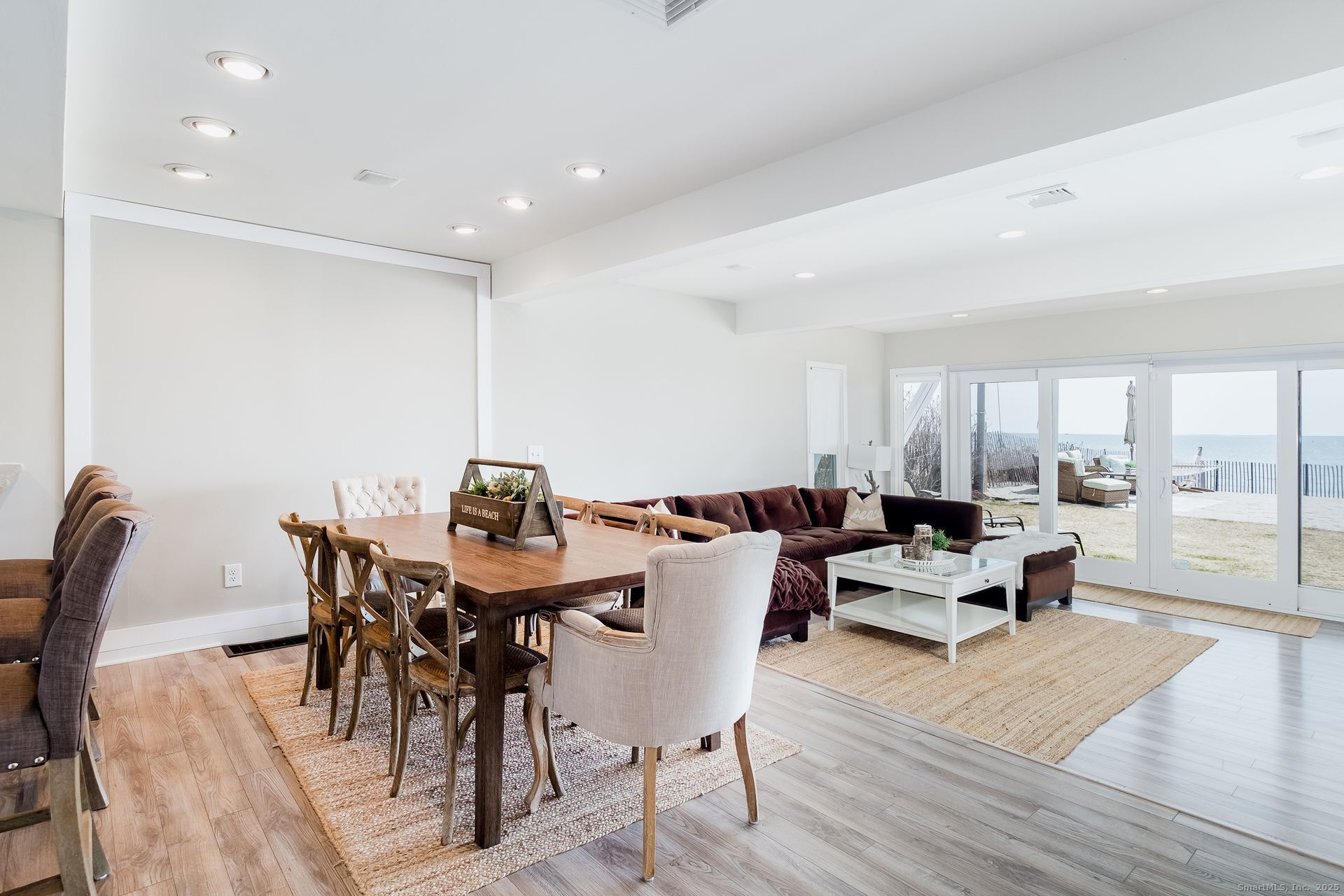 1987 Fairfield Beach Road Fairfield, CT 06824 - Photo 8 of 22 a view of a dining room with furniture wooden floor and chandelier