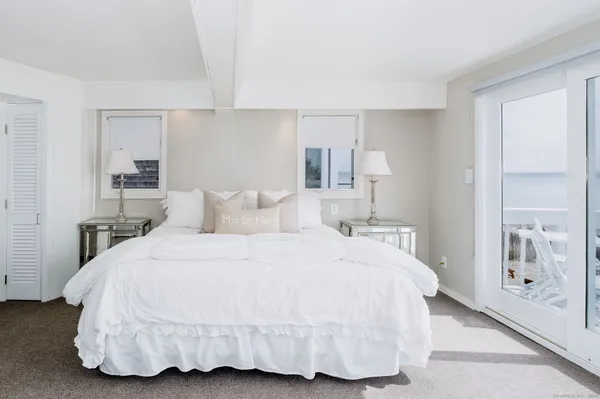 a bedroom with a bed and a lamp
