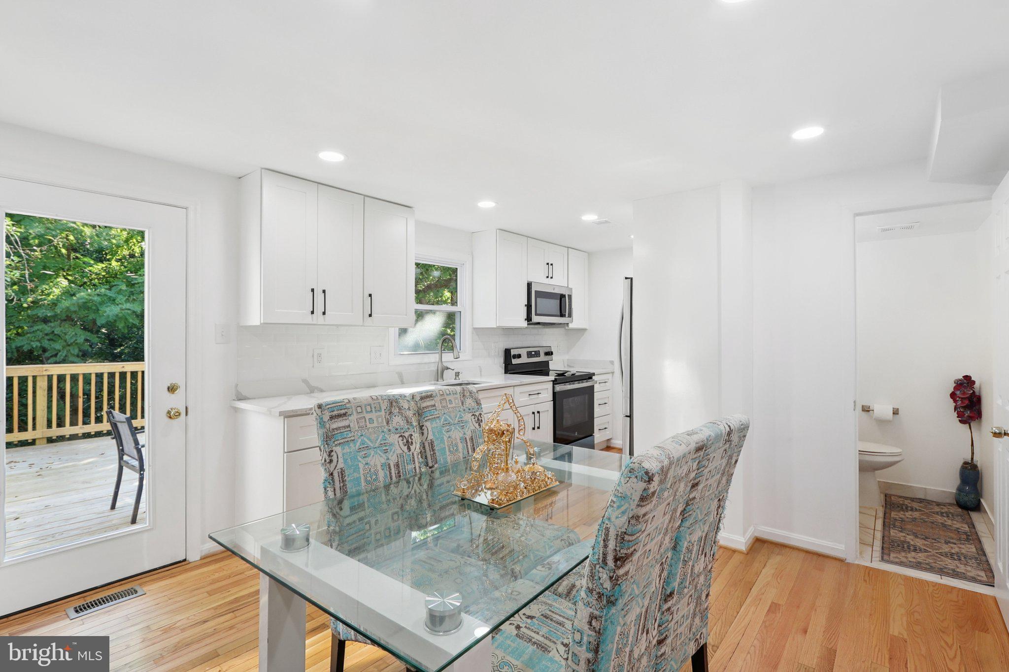 6246 Hillside Road Springfield, VA 22152 - Photo 12 of 41 a living room with stainless steel appliances furniture a rug and a kitchen view