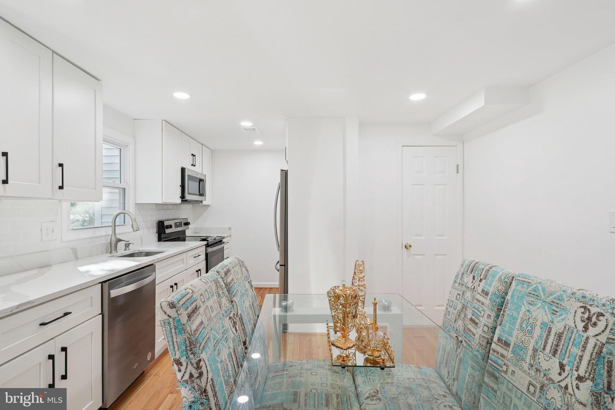 6246 Hillside Road Springfield, VA 22152 - Photo 14 of 41 a view of a kitchen with furniture and wooden floor