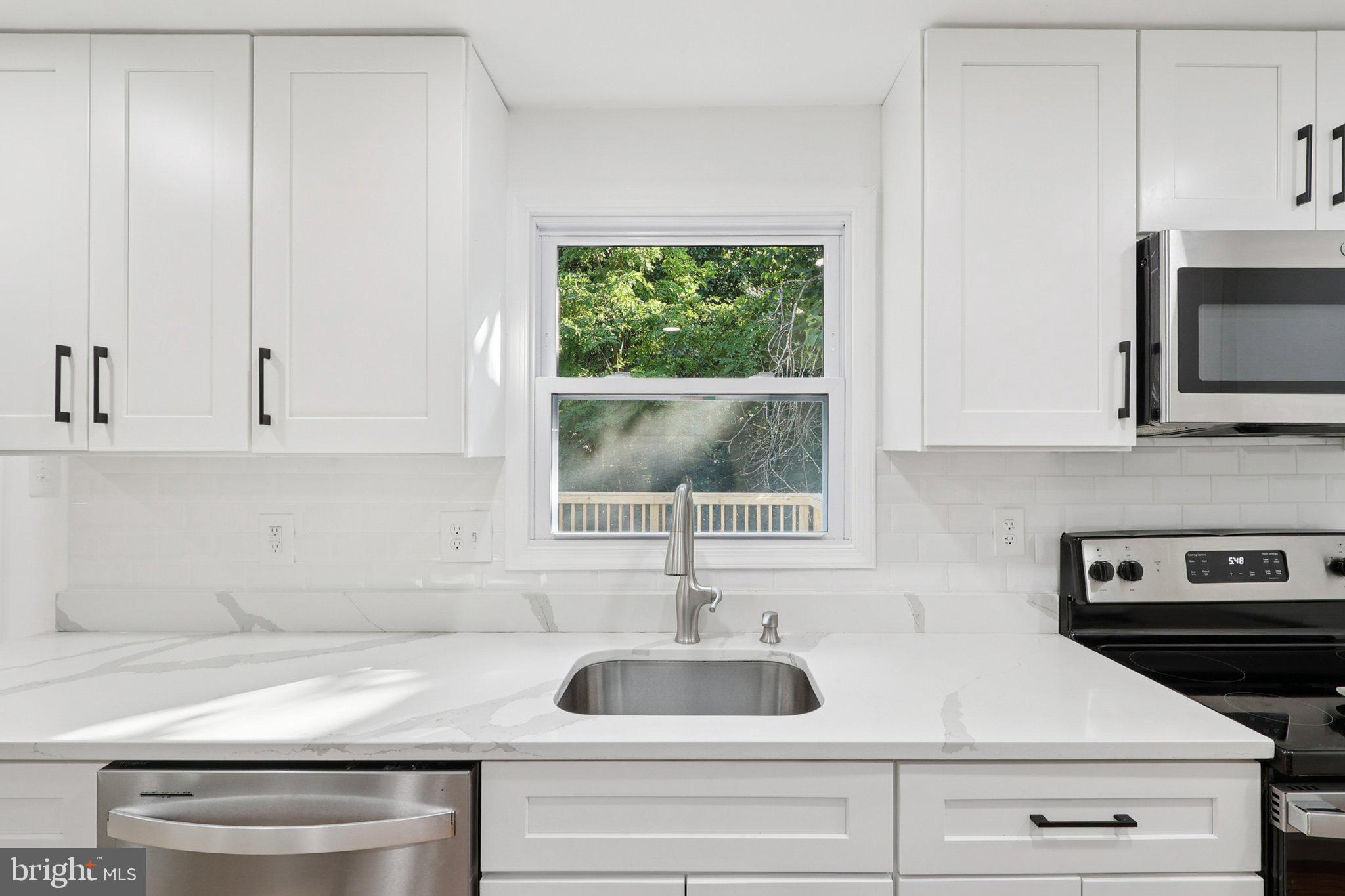 6246 Hillside Road Springfield, VA 22152 - Photo 18 of 41 a kitchen with appliances a sink and a window