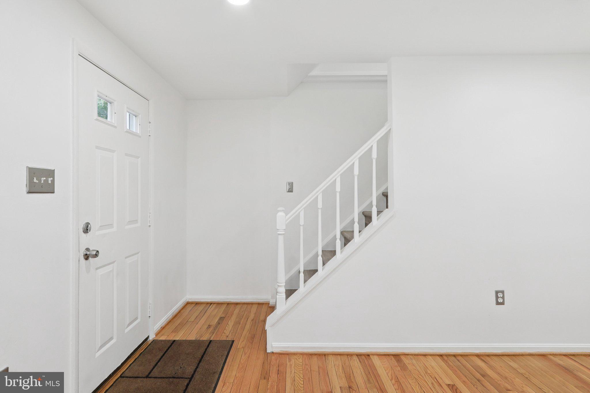 6246 Hillside Road Springfield, VA 22152 - Photo 4 of 41 a view of a hallway with wooden floor and entryway