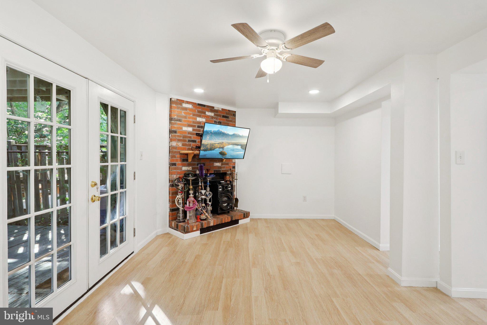6246 Hillside Road Springfield, VA 22152 - Photo 9 of 41 an empty room with wooden floor and windows