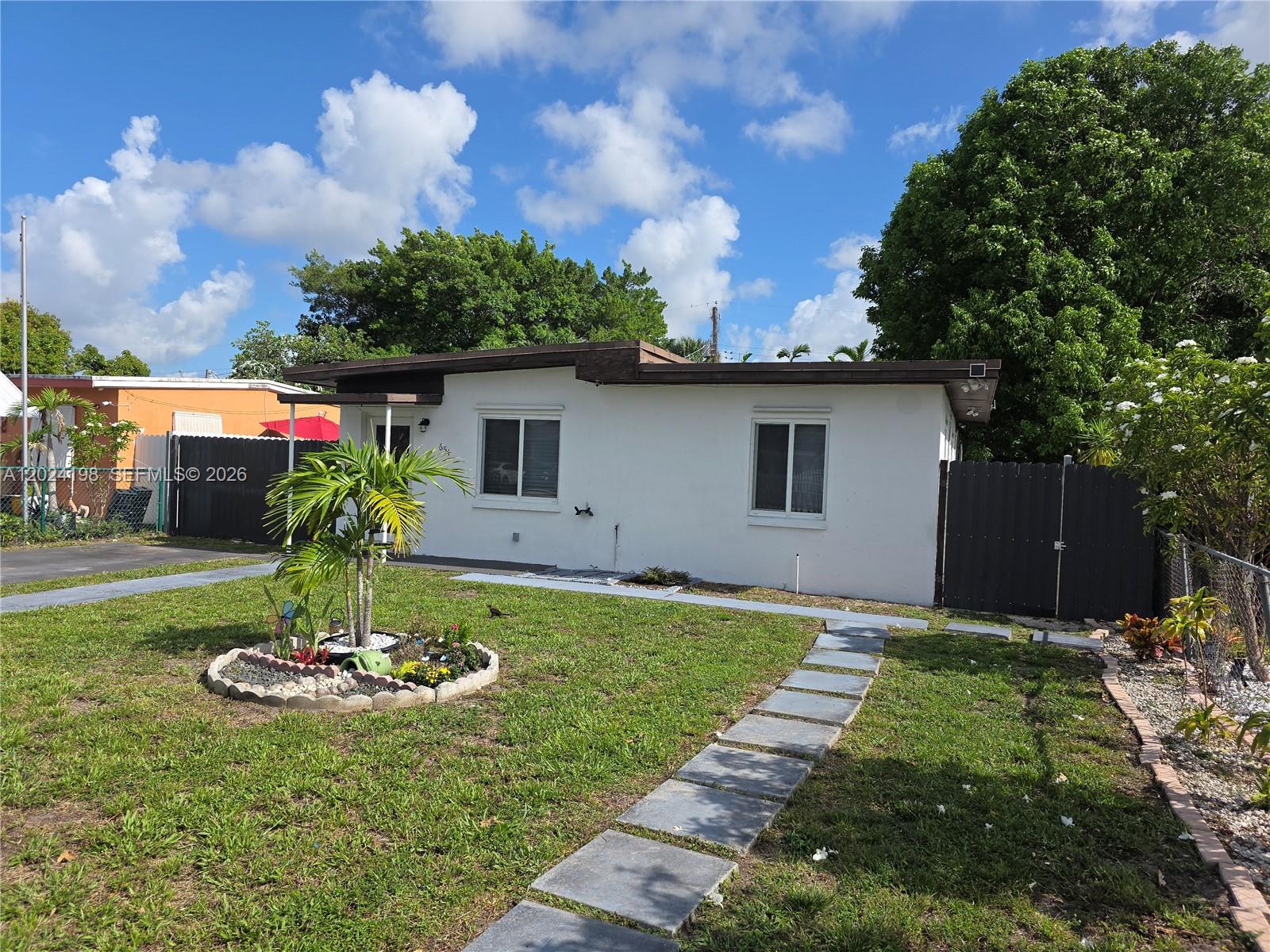 651 East 48th Street Hialeah, FL 33013 - Photo 3 of 52 a front view of a house with garden