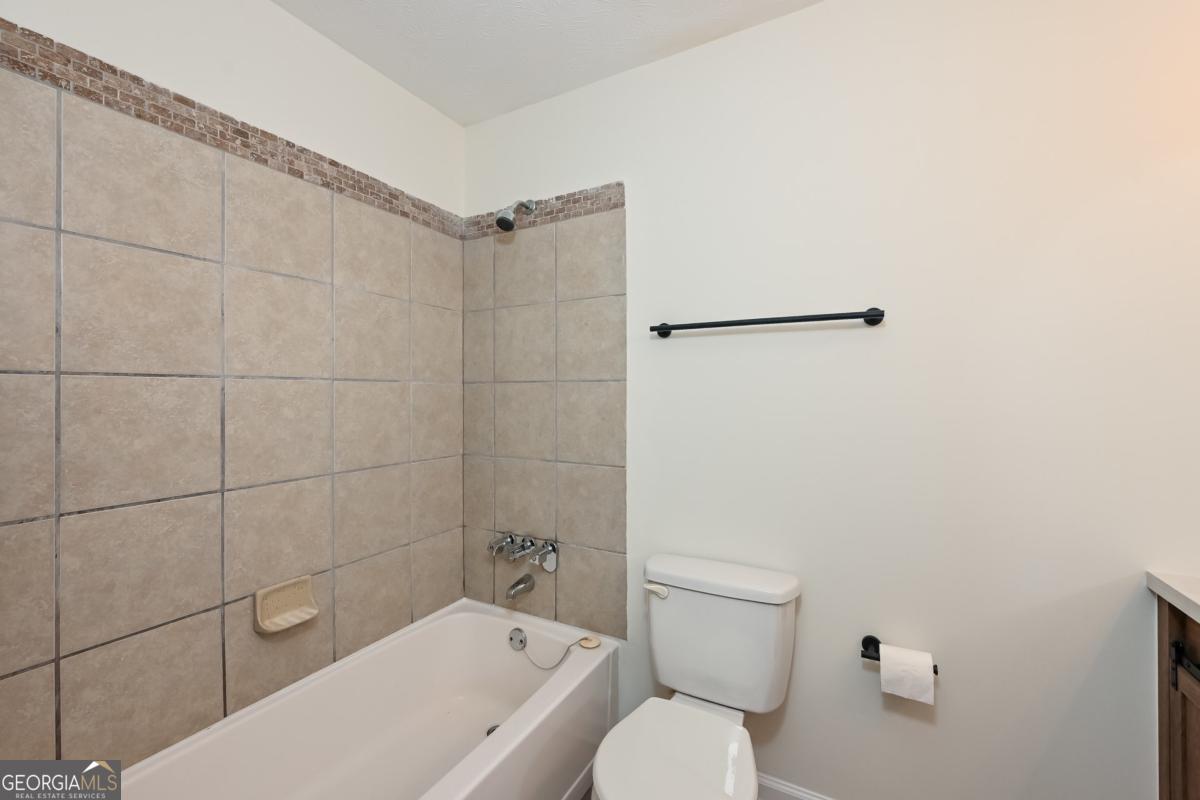 201 Lenox Way Northeast, Unit 201 Atlanta, GA 30324 - Photo 12 of 15 a bathroom with a toilet and shower