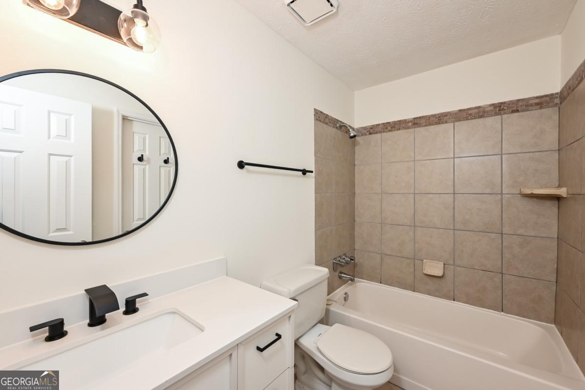 201 Lenox Way Northeast, Unit 201 Atlanta, GA 30324 - Photo 13 of 15 a bathroom with a sink toilet and shower