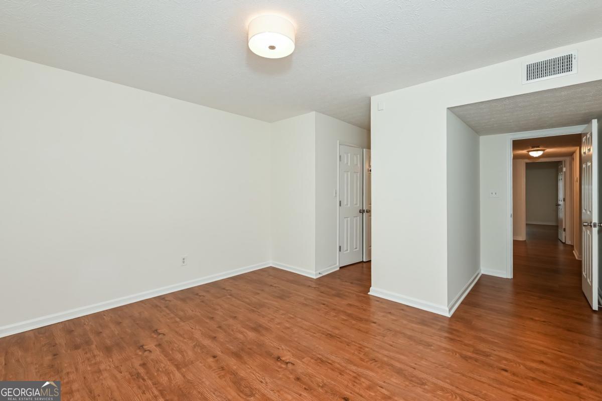 201 Lenox Way Northeast, Unit 201 Atlanta, GA 30324 - Photo 8 of 15 a view of a room with wooden floor