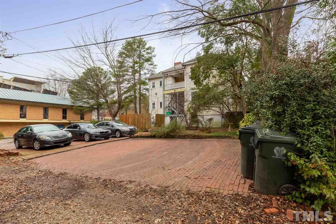 112 Forest Road Raleigh, NC 27605 - Photo 2 of 14 a view of a yard and a car parked on the road