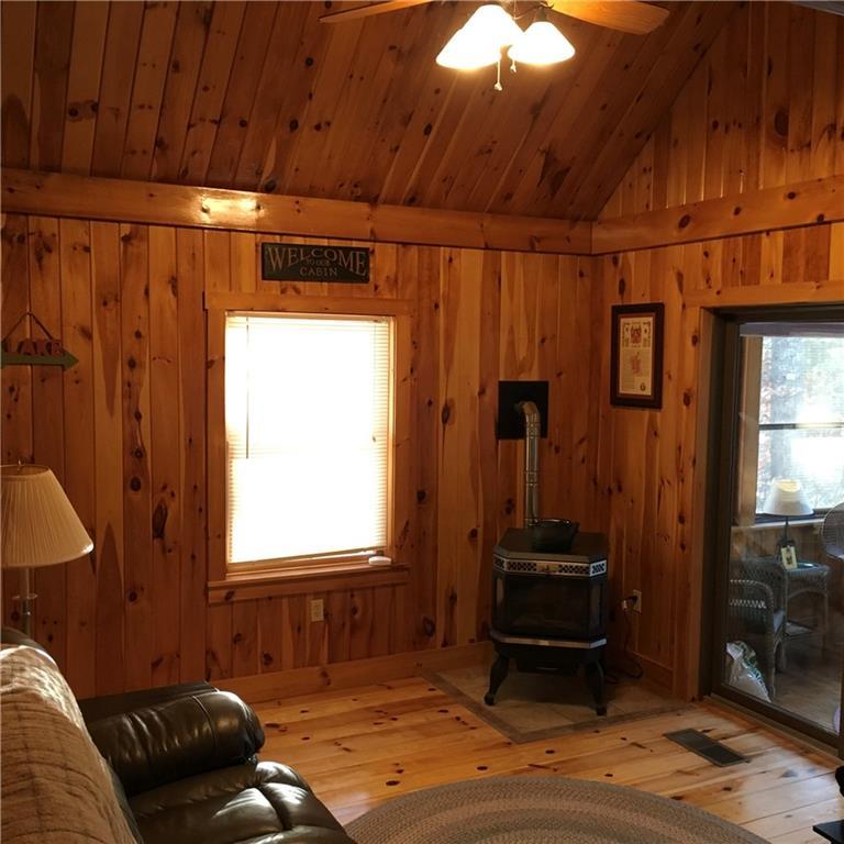 51 Kettle Pond Road, Unit 7 Shapleigh, ME 04076 - Photo 7 of 24 Living room with pellet stove for...