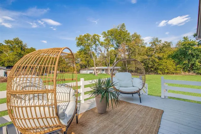 a view of a swimming pool with furniture and a garden