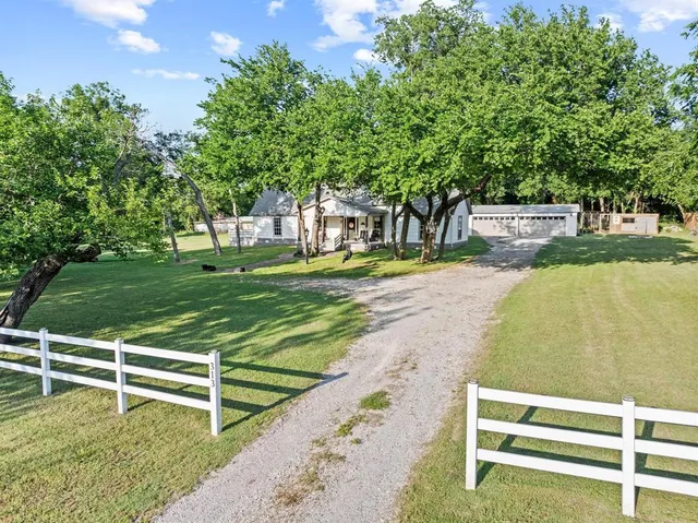 a view of a swimming pool with a bench and trees around