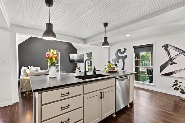 a kitchen with sink cabinets and wooden floor
