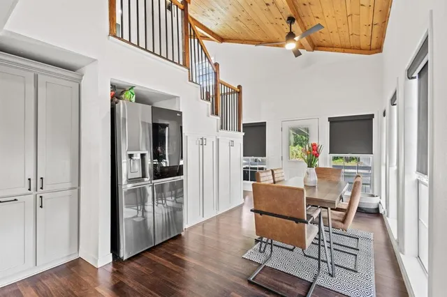 a living room with furniture and a kitchen view