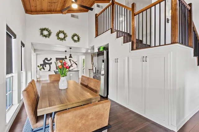 a dining room with furniture and wooden floor