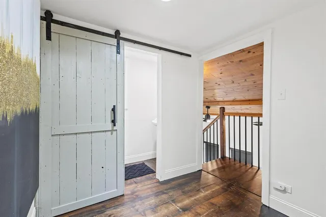 a view of a hallway to rooms