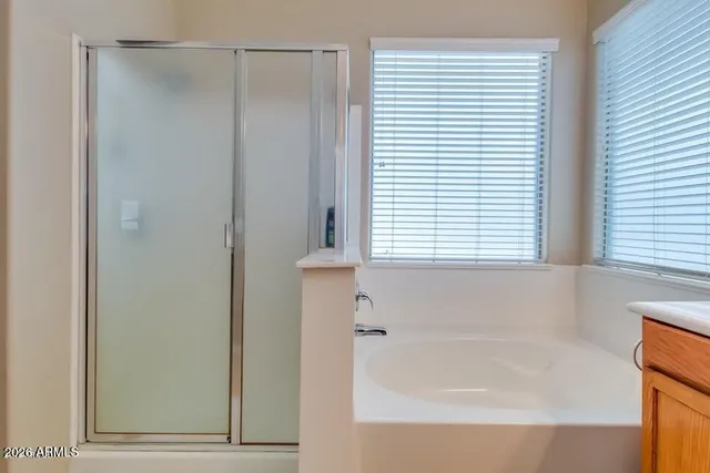 a bathroom with a bathtub and a window