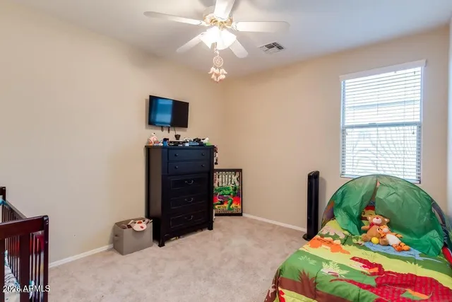 a bedroom with a bed and a chandelier