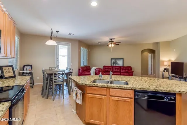 a kitchen with kitchen island granite countertop a table and chairs in it