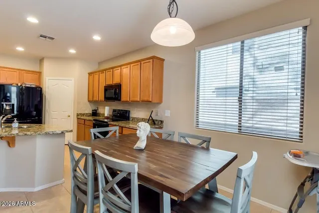 a view of a dining room with furniture and a window