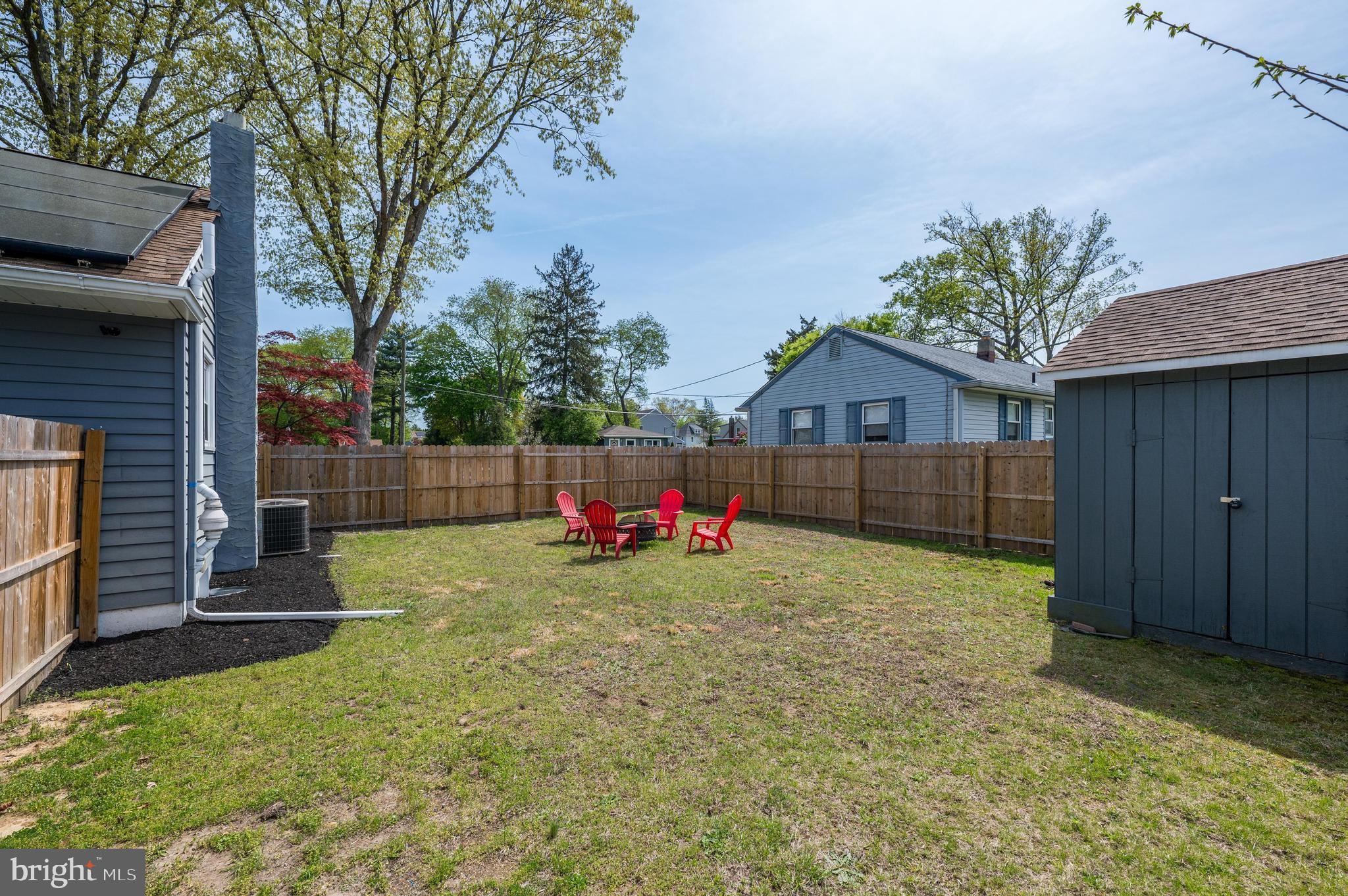 500 Jackson Avenue Magnolia, NJ 08049 - Photo 18 of 21 a view of backyard with wooden fence and a large tree