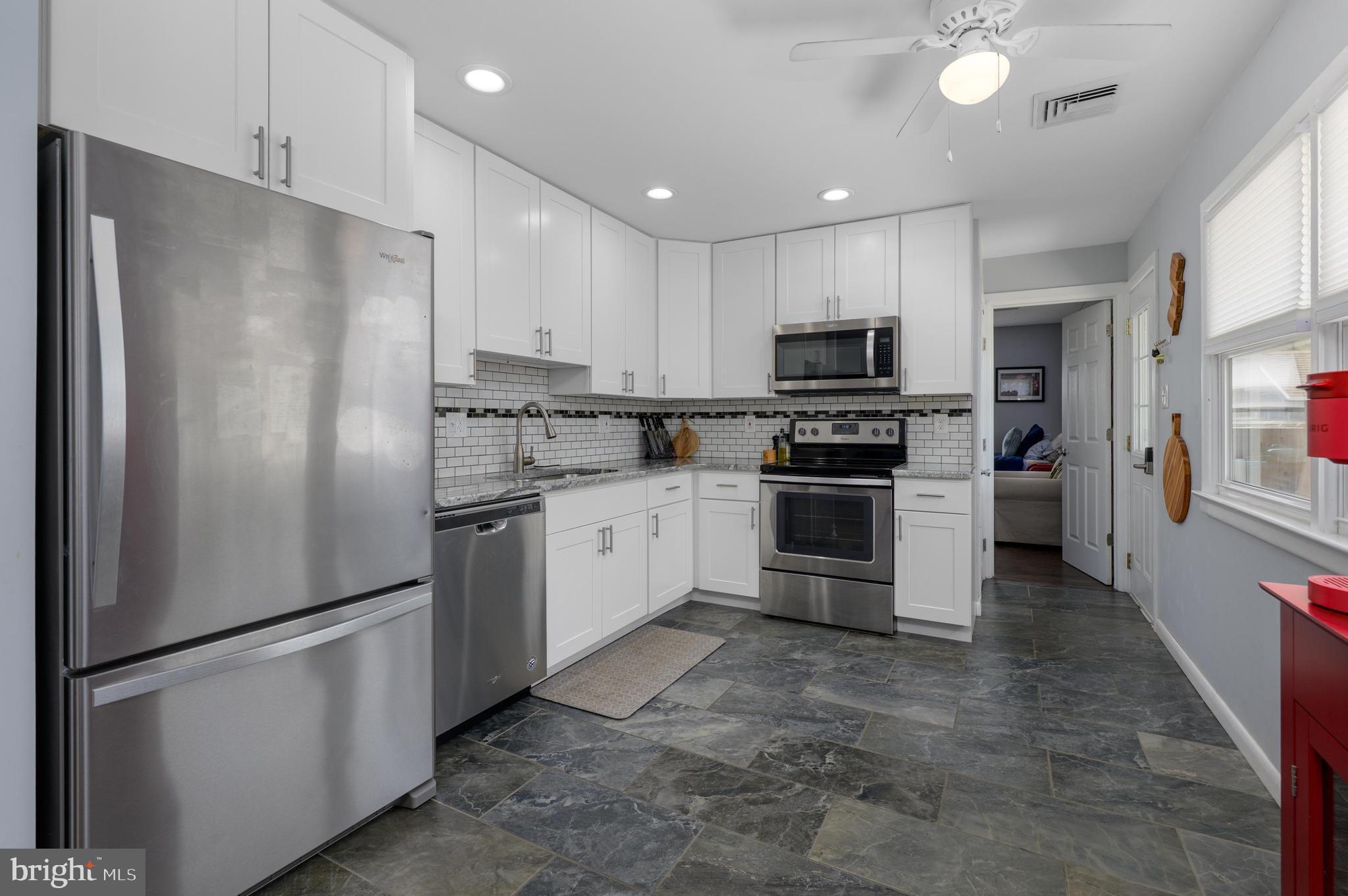 500 Jackson Avenue Magnolia, NJ 08049 - Photo 6 of 21 a kitchen with stainless steel appliances cabinets and a refrigerator