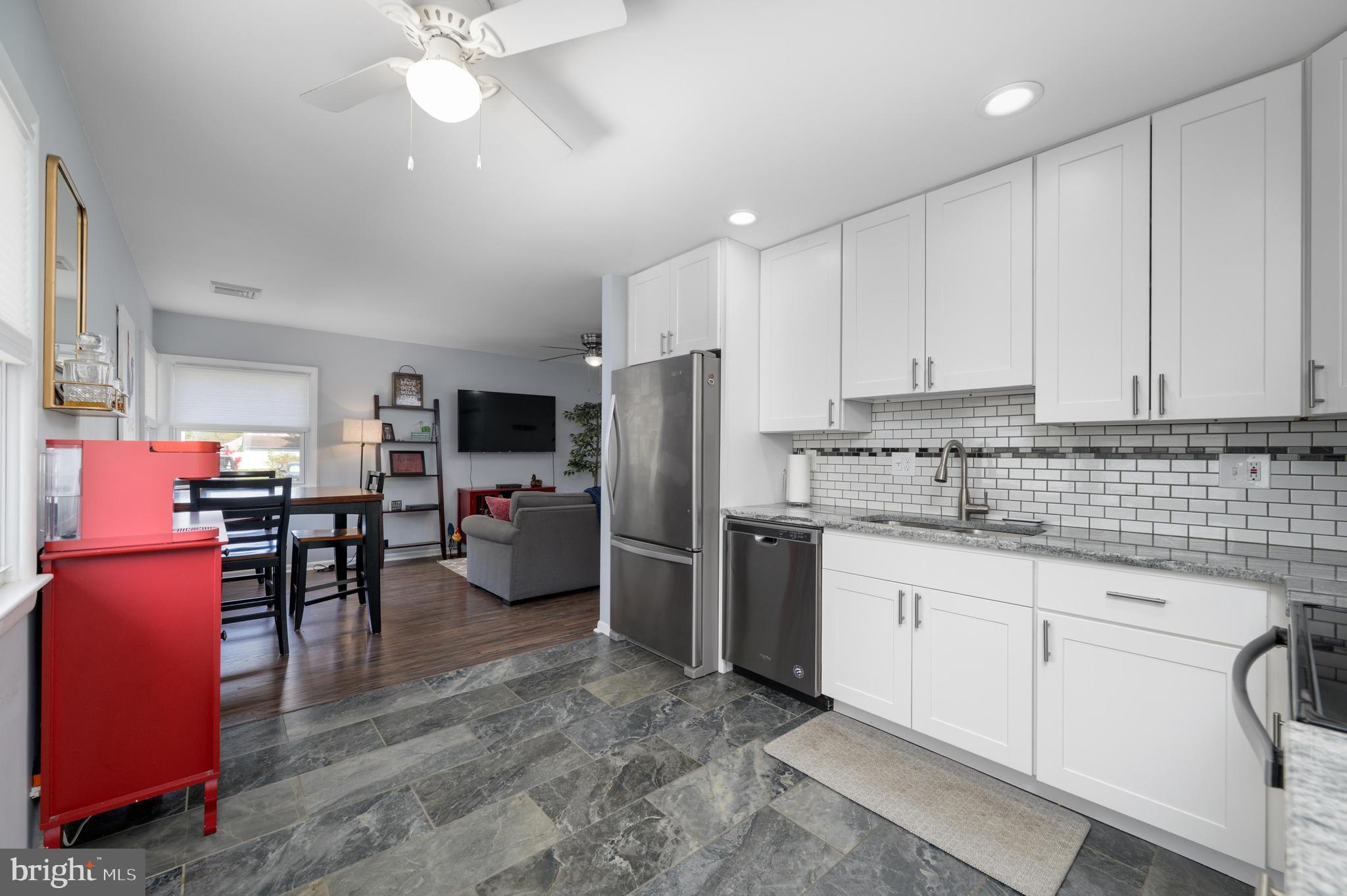 500 Jackson Avenue Magnolia, NJ 08049 - Photo 7 of 21 a kitchen with refrigerator cabinets and furniture