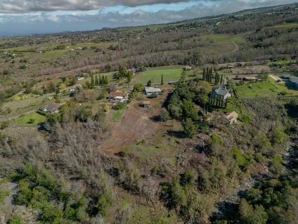 an aerial view of a houses with a yard