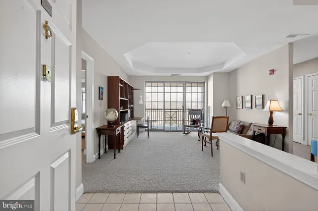 a living room with furniture and large windows