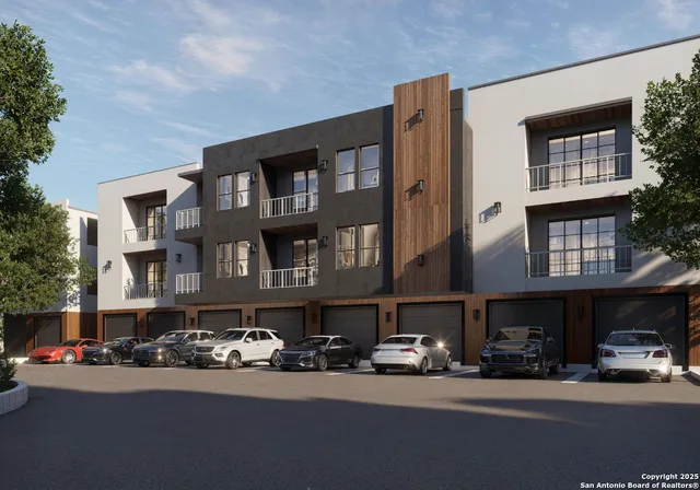 a city street lined with buildings and cars parked in front of it