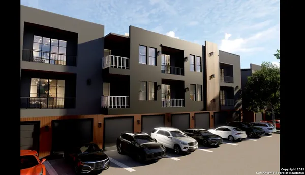 a couple of cars parked in front of a building