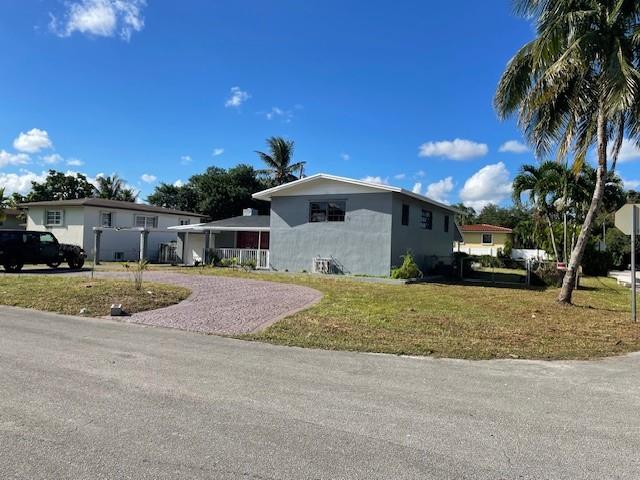 Ives Estates Miami, FL 33179 - Photo 2 of 2 a front view of a house with a yard and garage