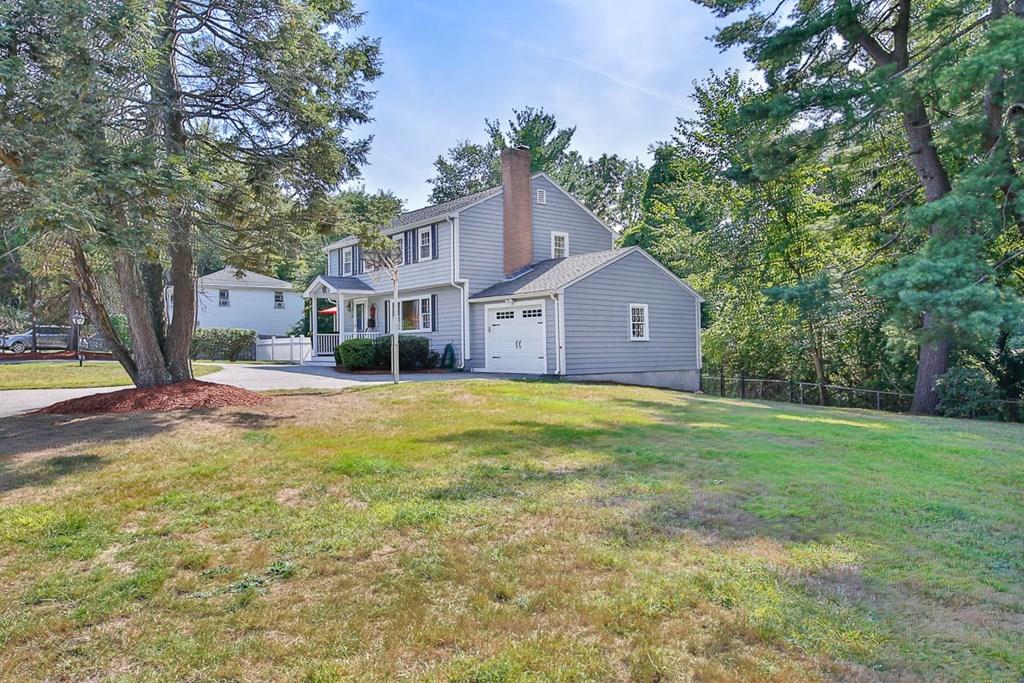 10 Ross Road Lexington, MA 02421 - Photo 3 of 36 a front view of a house with a garden and tree